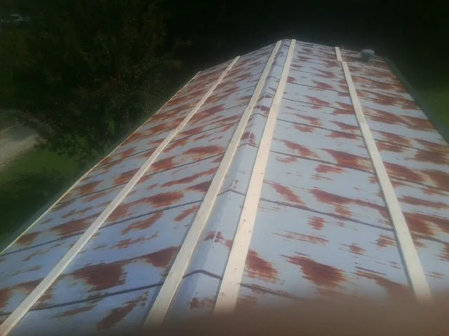 Rusted metal roof panels with new wood purlins before replacement — Storm Damage Roof Repair in Congers by Roofing Brothers